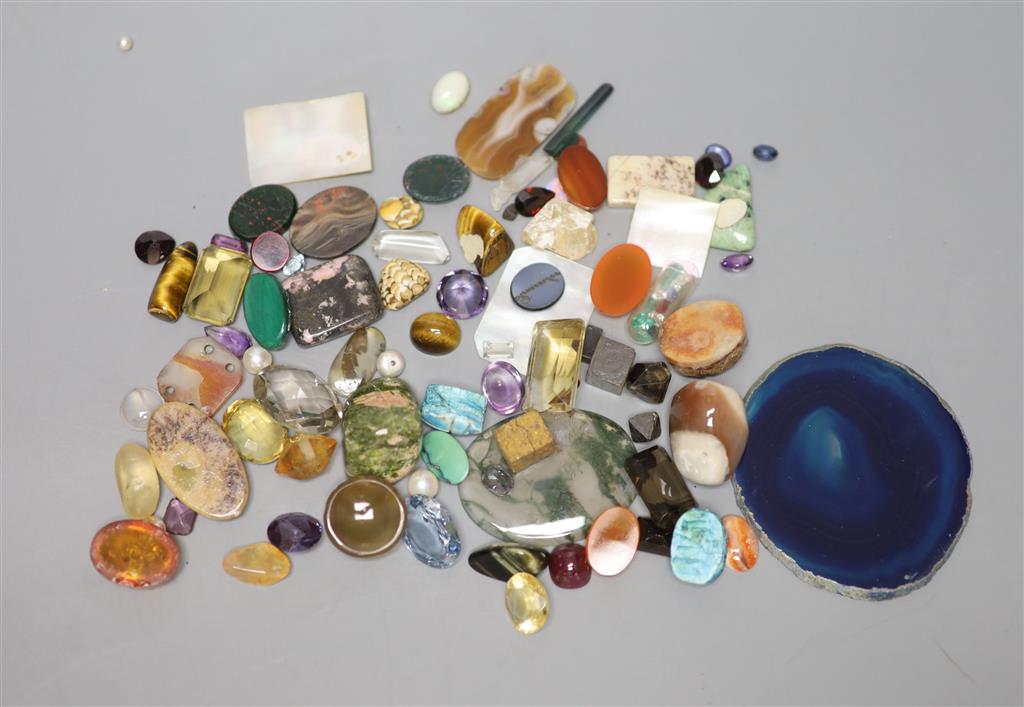 A group of loose precious and semi precious stones, including citrine, moss agate, tigers eye quartz etc.